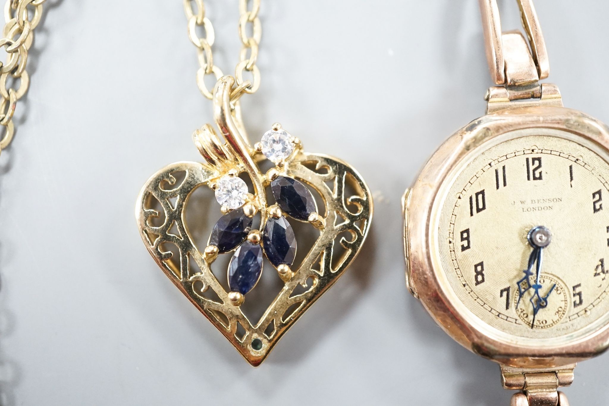 A lady's early 20th century 9ct gold manual wind wrist watch, on a 9ct strap(a.f.), gross weight 21.2 grams and a costume pendant on chain.
